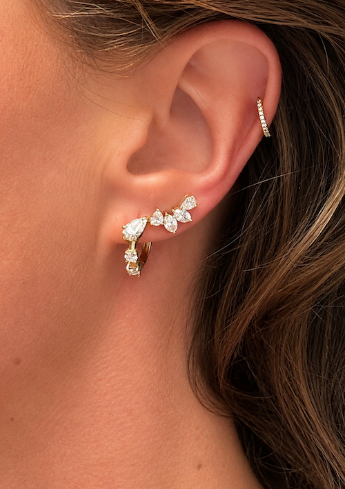 Side Piece climber stud featuring two pear cut and two marquise cut diamonds to climb up the ear styled on model in yellow gold— Waltz Diamonds