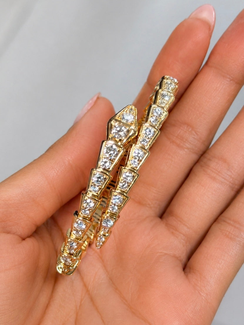Slither Diamond Wrap bangle in 14k yellow gold with diamond-set snake design held in hand — Waltz Diamonds