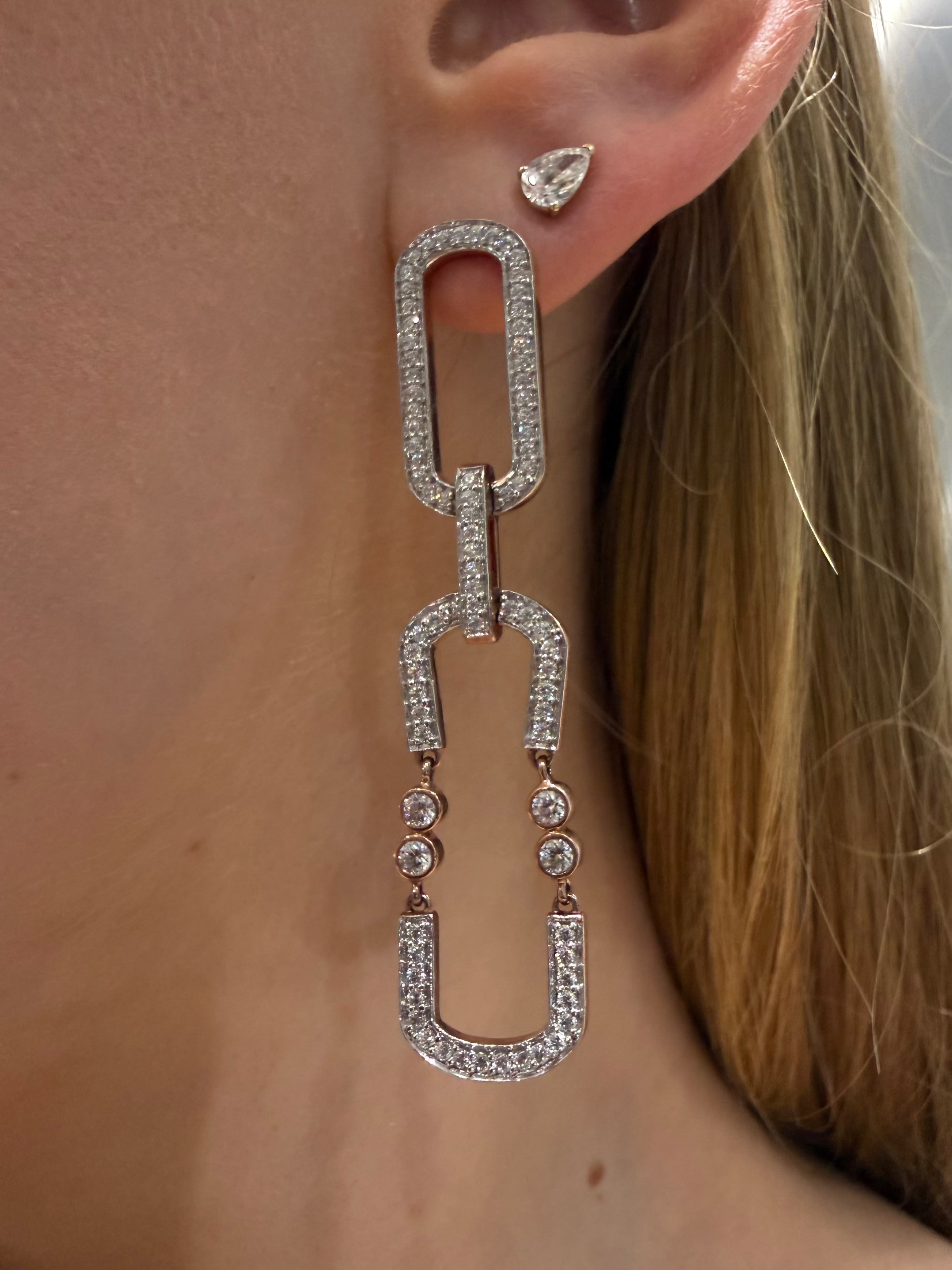 Swing Link Diamond statement earrings featuring two long pave links and bezel set diamonds in rose gold on ear — Waltz Diamonds