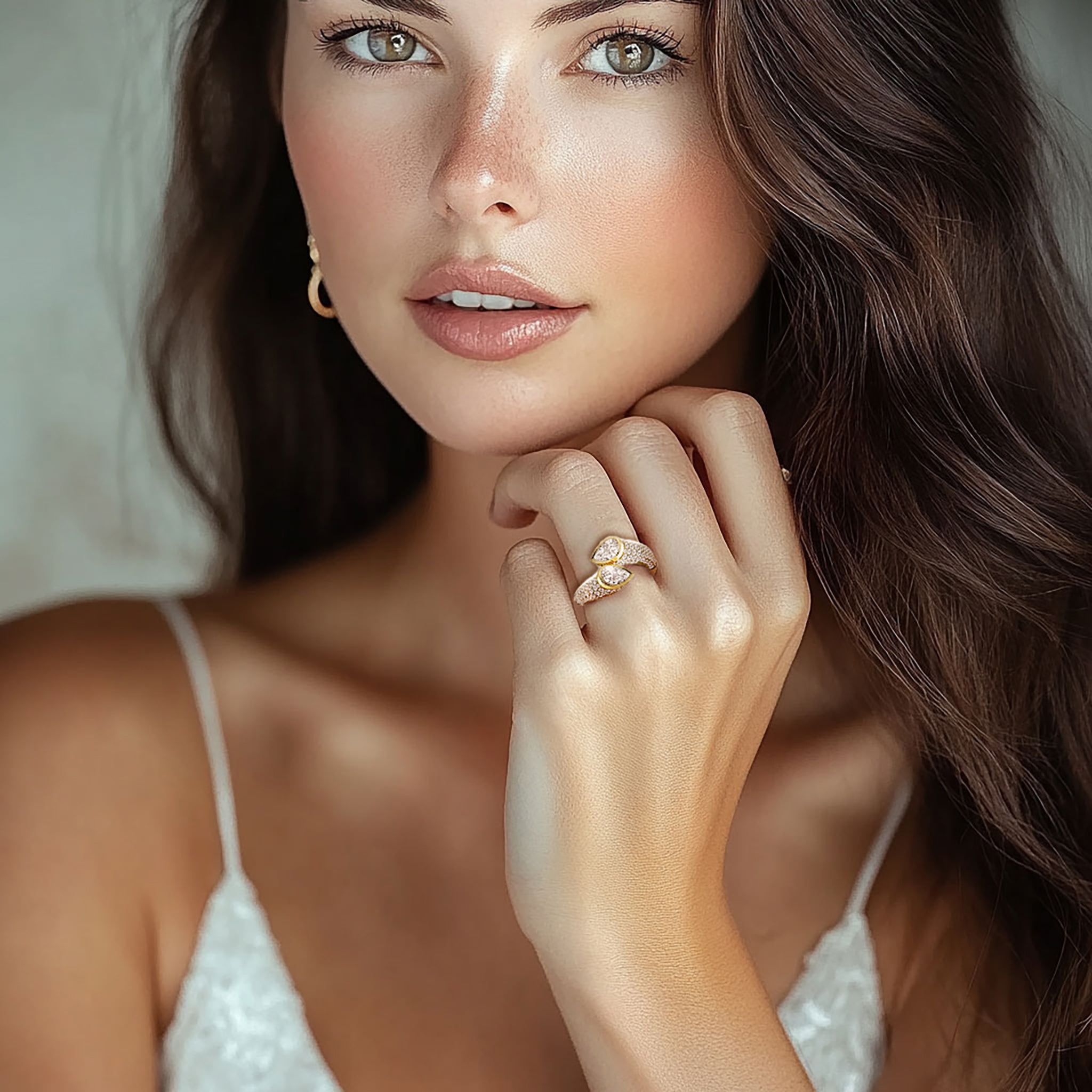 Twin flame bypass ring in yellow gold worn on model