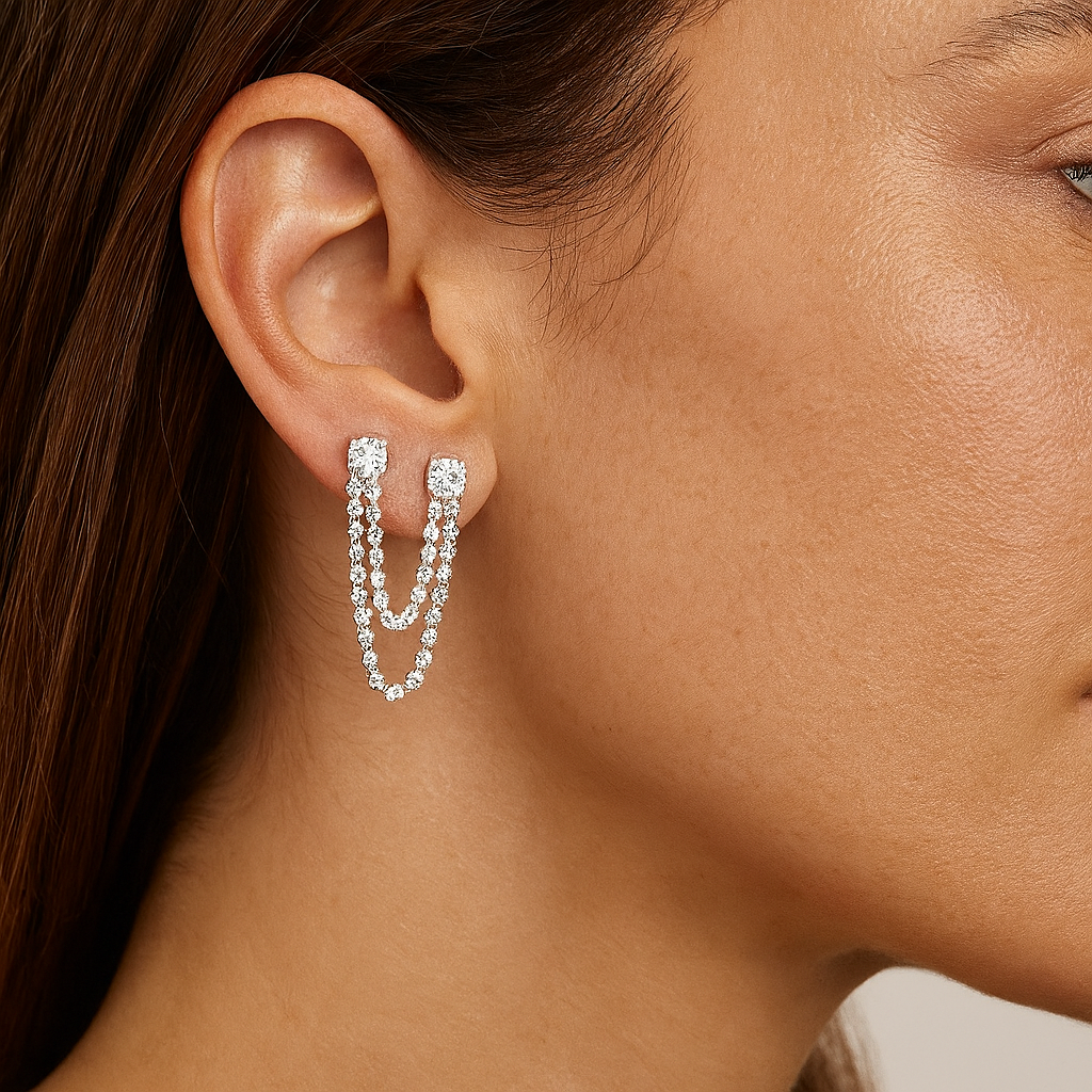 Model wearing two step diamonds drop earrings in white gold. Double piercing.