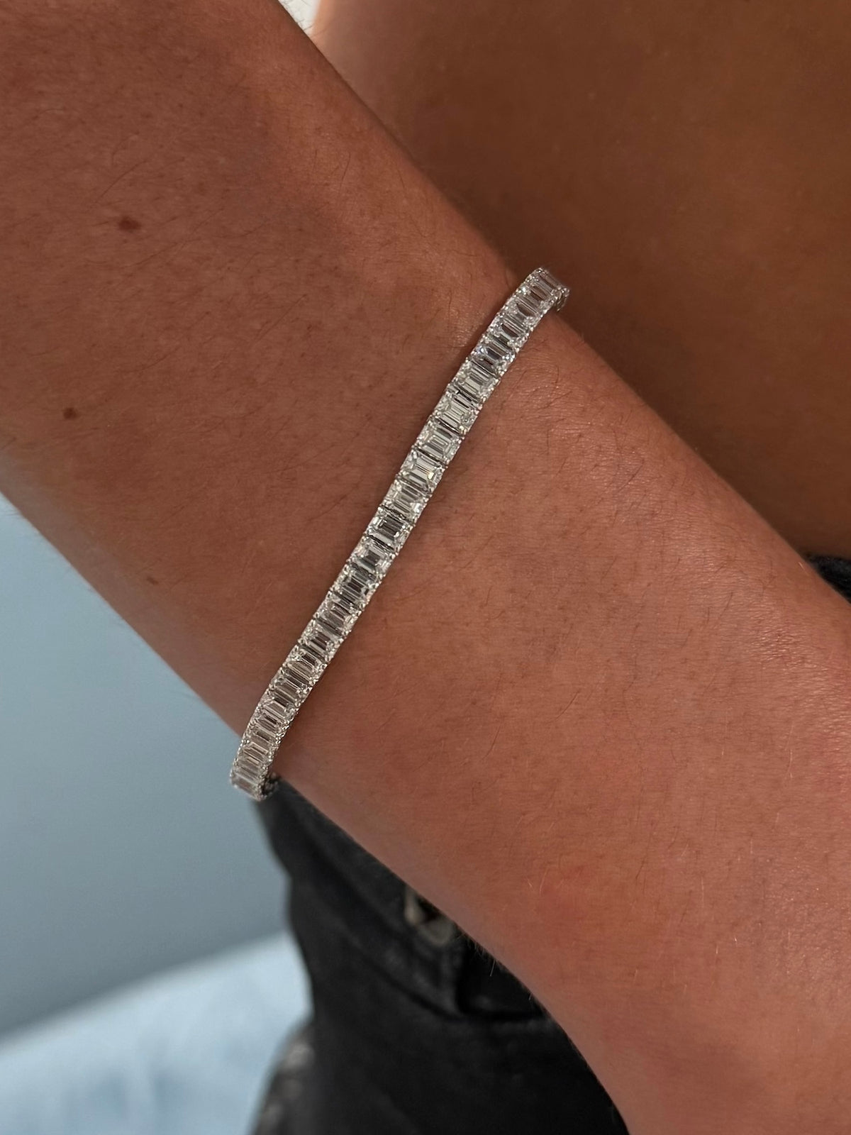 Always Evolving emerald cut diamond tennis bracelet 10 carat worn on model —Waltz Diamonds