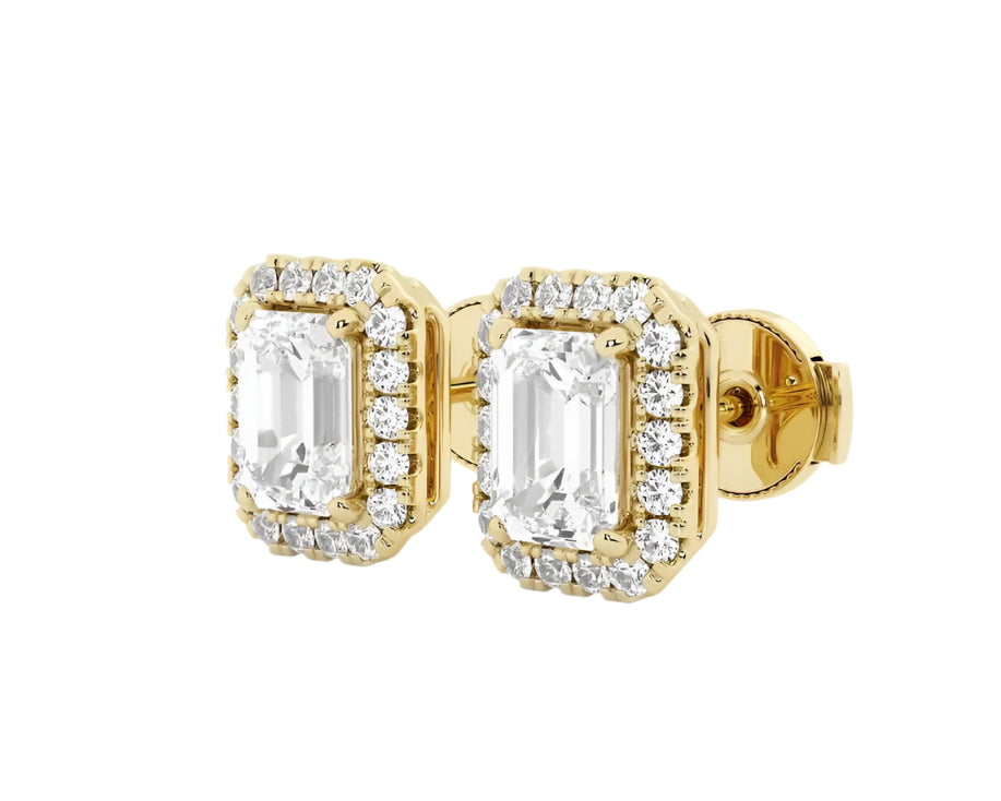 Angel Studs in yellow gold with emerald-cut center stones and diamond halo, diagonal angle