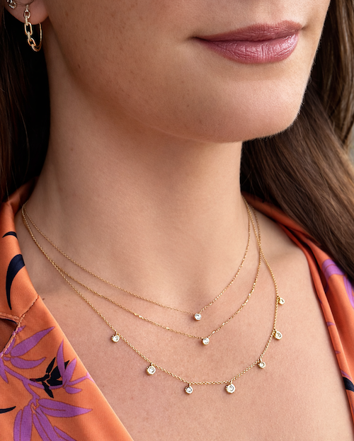 Baby Bezel Petite Diamond Necklace styled with Dirty Dancing Bezeled Diamond Necklace stacked gold necklaces on model —Waltz Diamonds