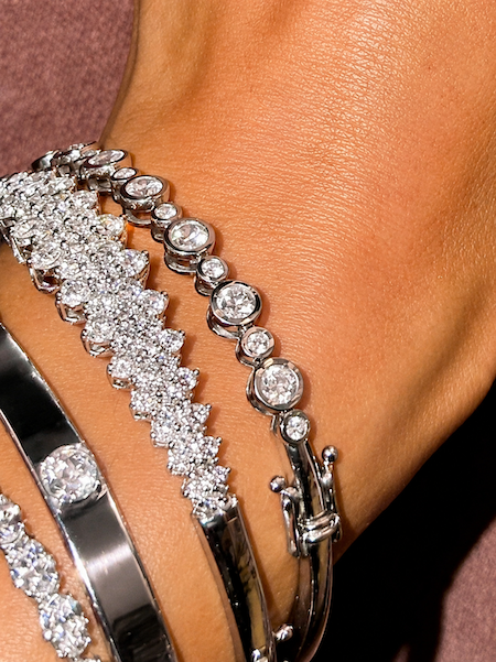Bubble bezel diamond bangle in white gold 19 diamonds styled on wrist — Waltz Diamonds 