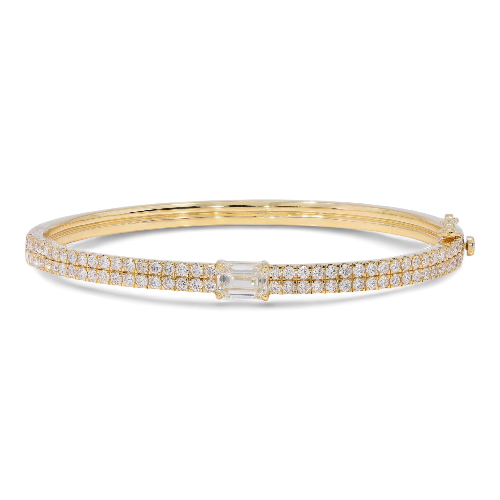 The Clarity Bangle in yellow gold featuring emerald-cut center diamond and pavé details, front view with inner design visible