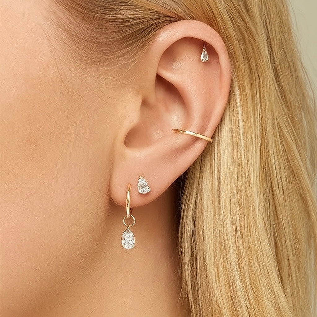 Model wearing Cleo's Lucky Ear Charm in a stacked earring look, styled in the helix piercing