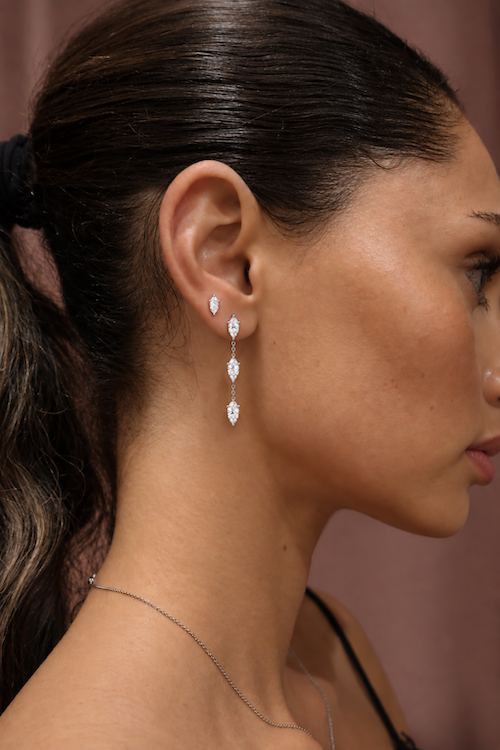 Dancing diamond earrings three pear cut drop earrings in white gold on model — Waltz Diamonds