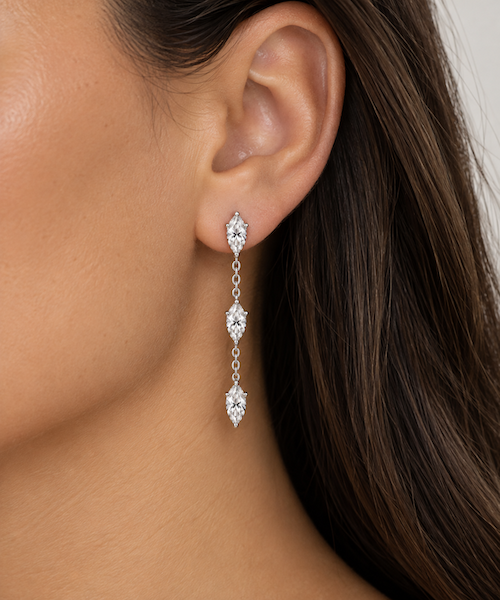 Dancing diamond earrings three marquise cut drop earrings in white gold on model — Waltz Diamonds