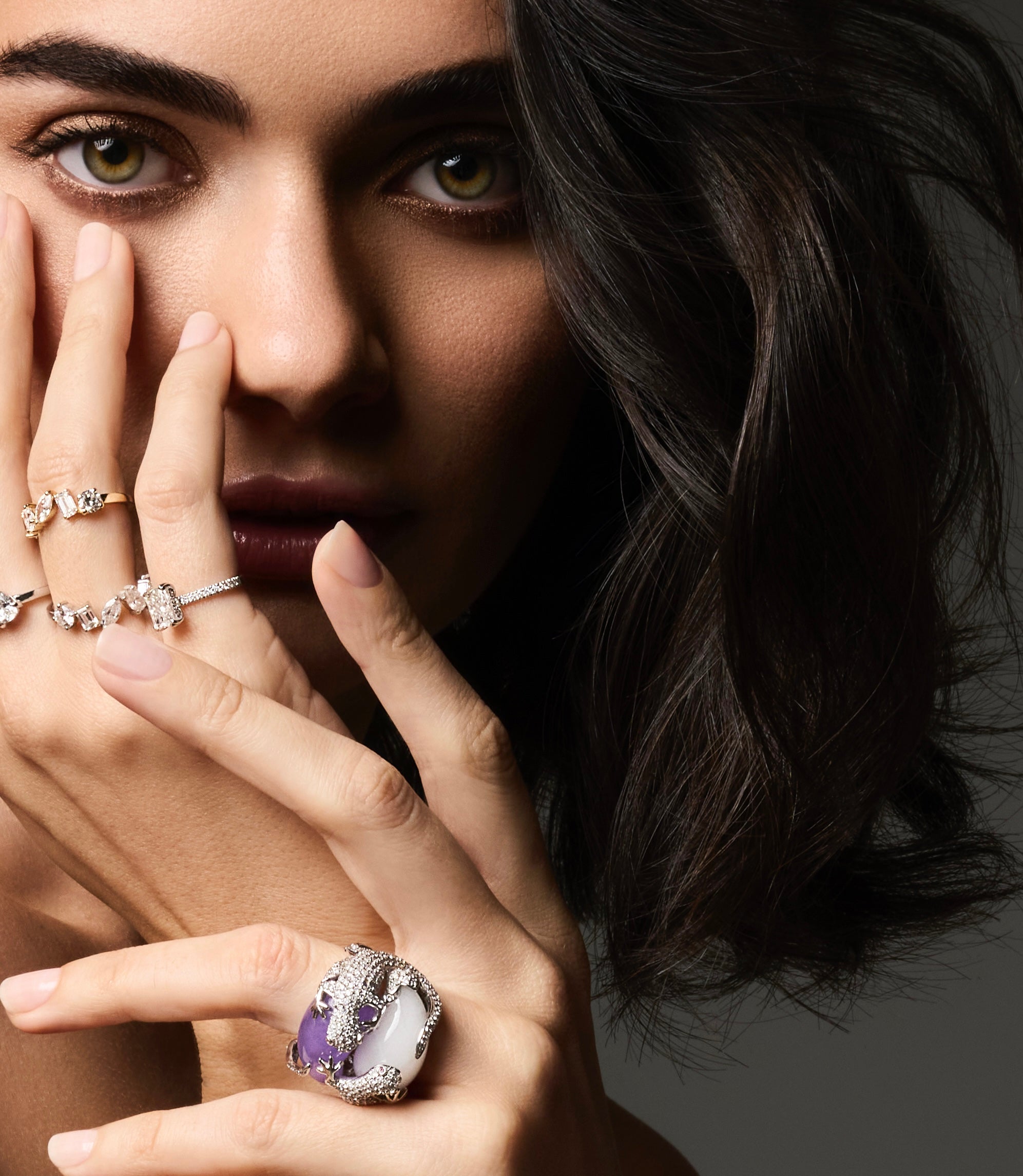 Model wearing a stacked ring set featuring the Diversity Band with mixed-shape diamonds and Lizard Hugs Jade and Diamond Ring