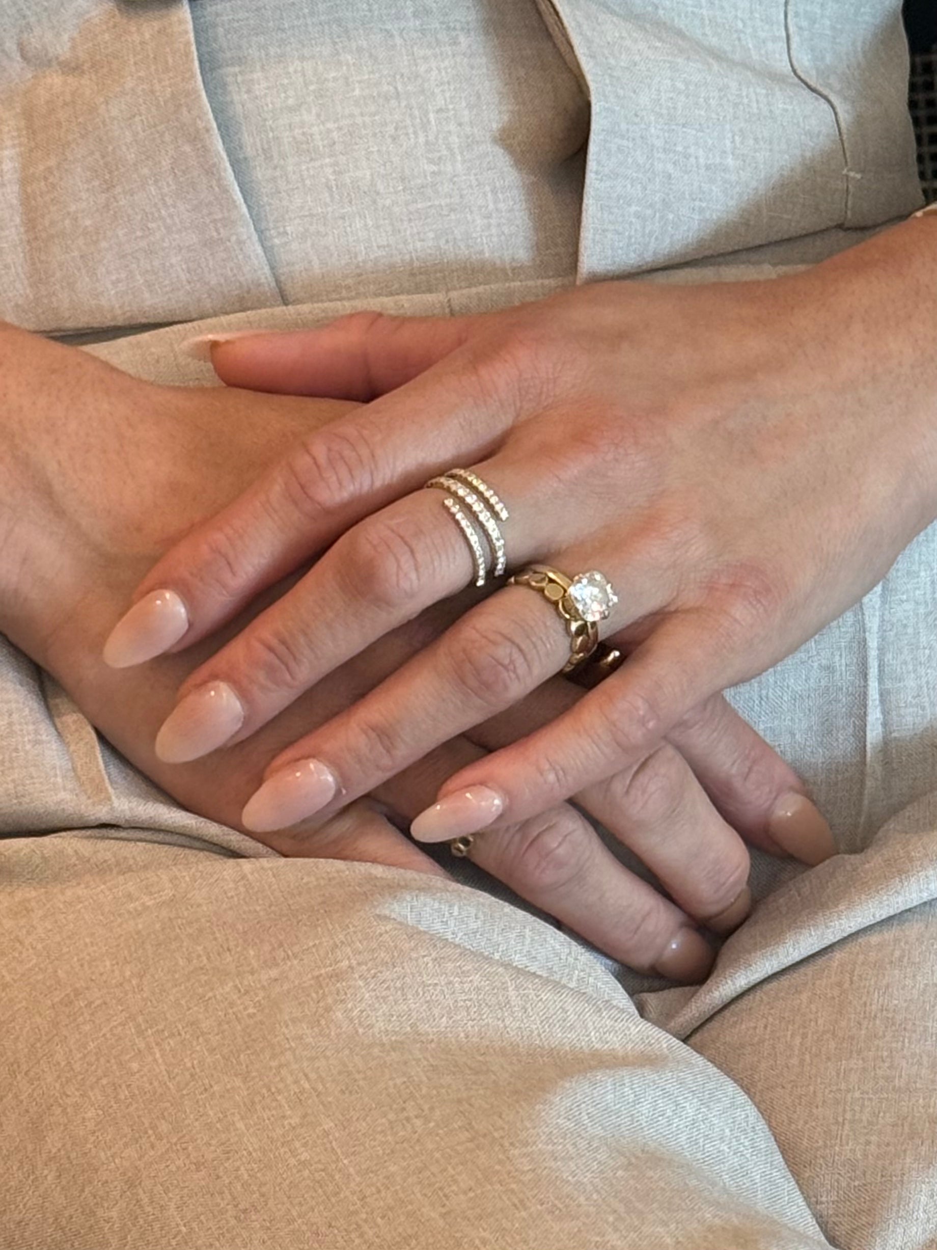 I am worthy spiral wrap ring in yellow gold worn on models hand.