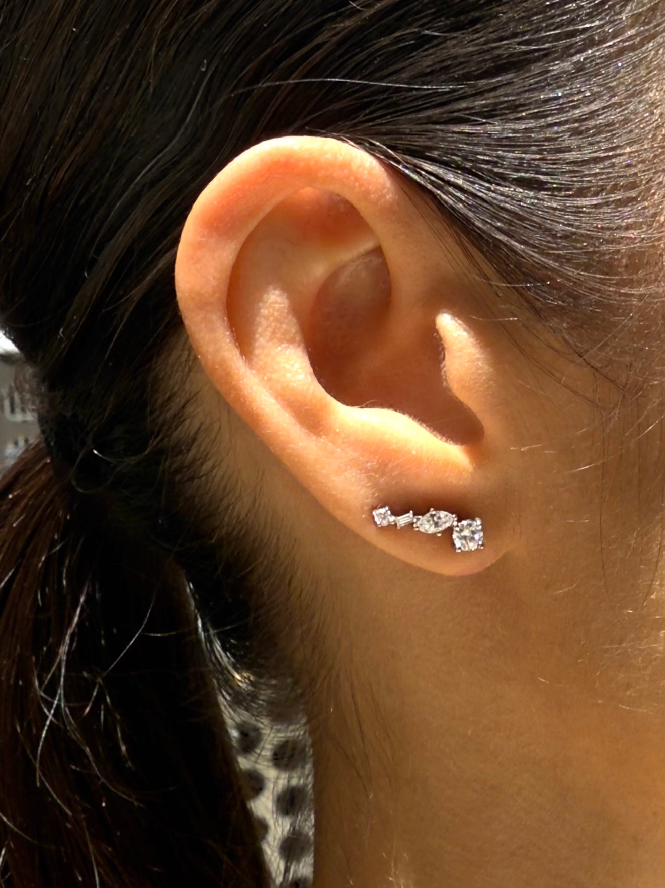 Editorial shot of Social Climbers diamond ear climber in white gold worn on model ear