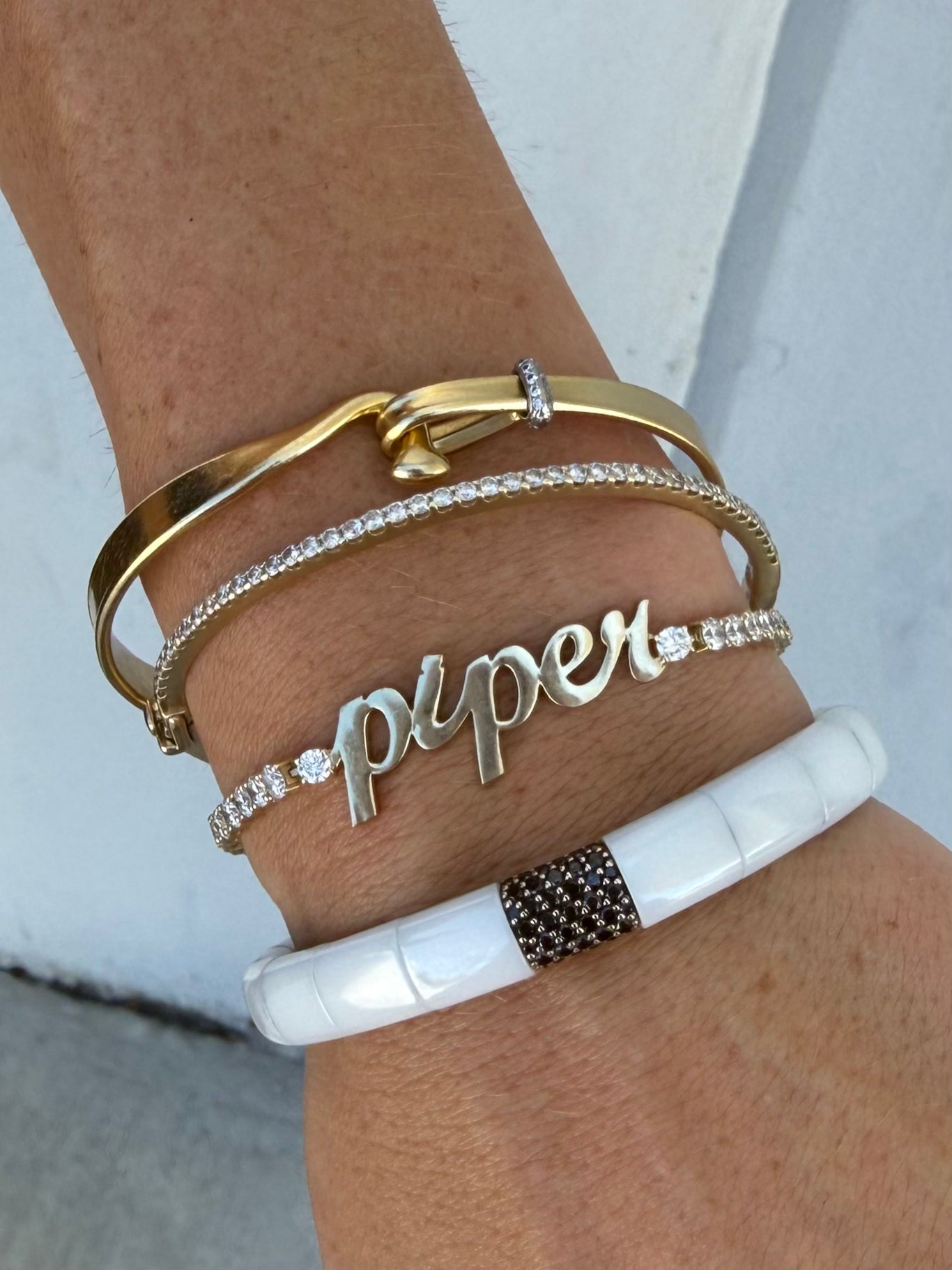 Spoil me with sparkles diamond tennis bracelet custom designed with "piper" in yellow gold stacked on model—Waltz Diamonds