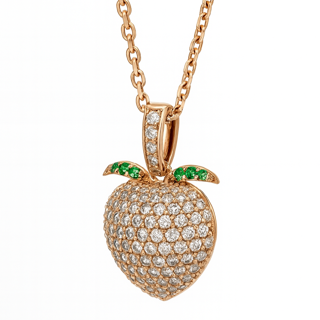 Rose gold sweet peach pendant with diamond accents and green gemstones on a white background