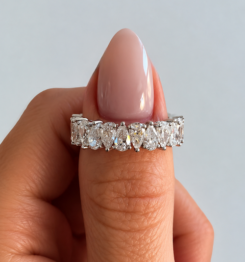 Tears of Joy rotating pear cut diamond eternity band in white gold on thumb — Waltz Diamonds